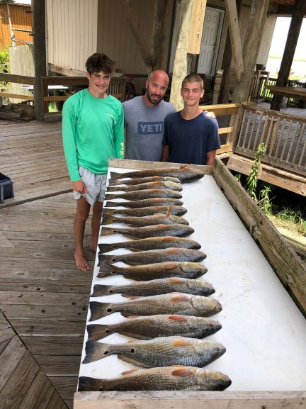 Shawn Doerle and sons with limit of redfish at victory bay charters